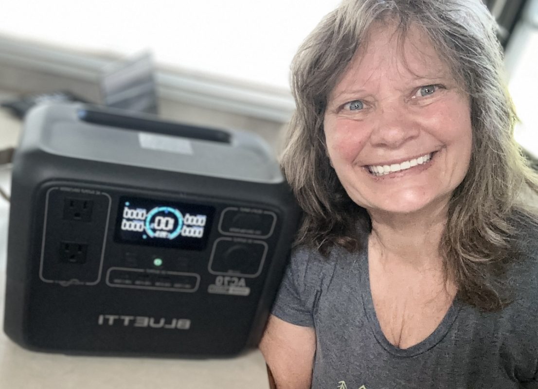 Bluetti AC Power station beside smiling woman