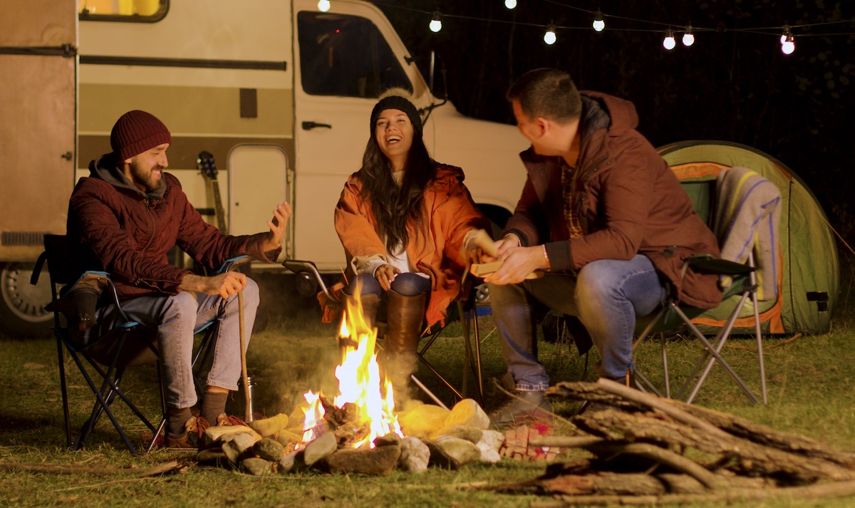 Group of close friends with camping chairs and rv highlighting RV reviews
