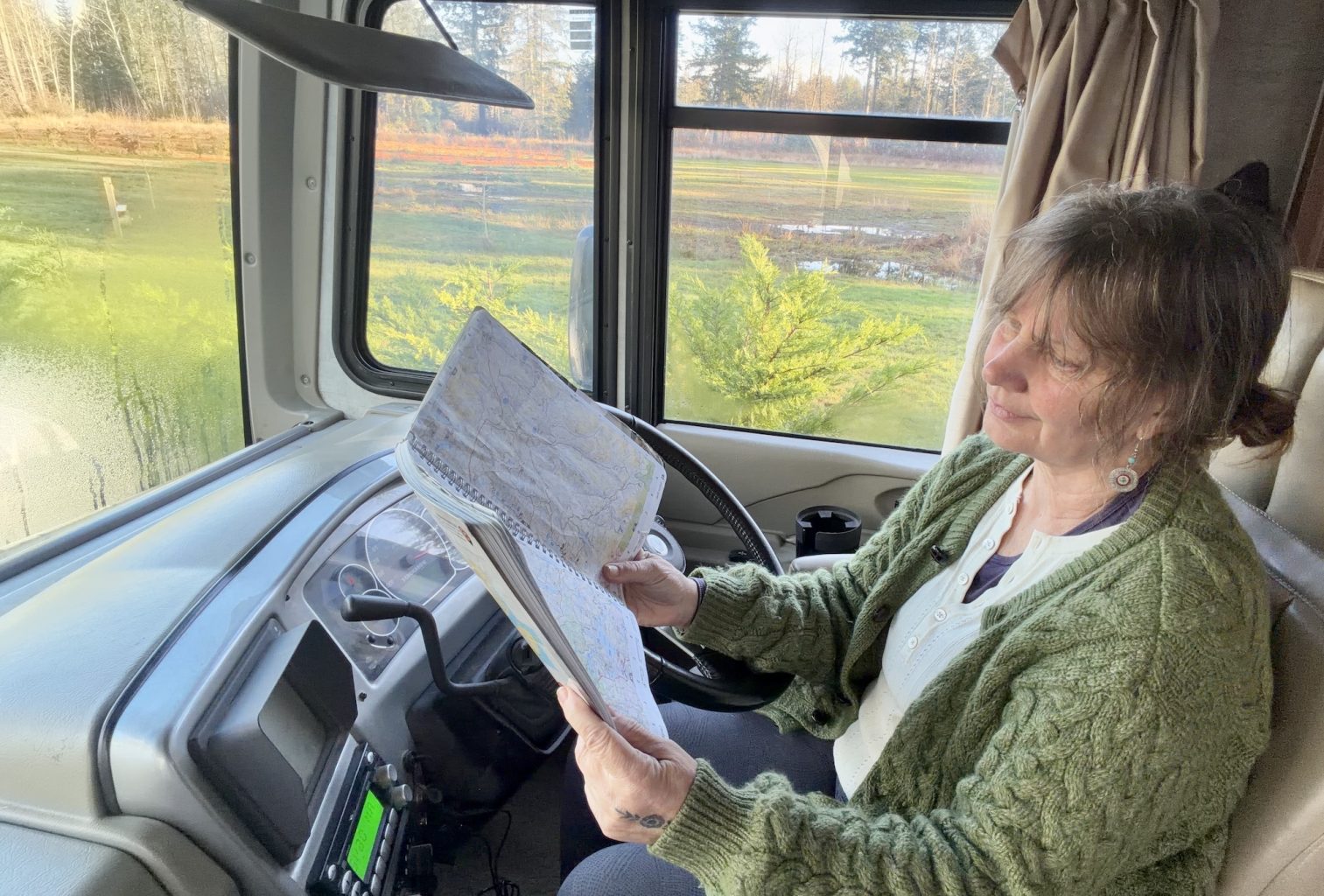 Lynne Fedorick trip planning with a map in her RV