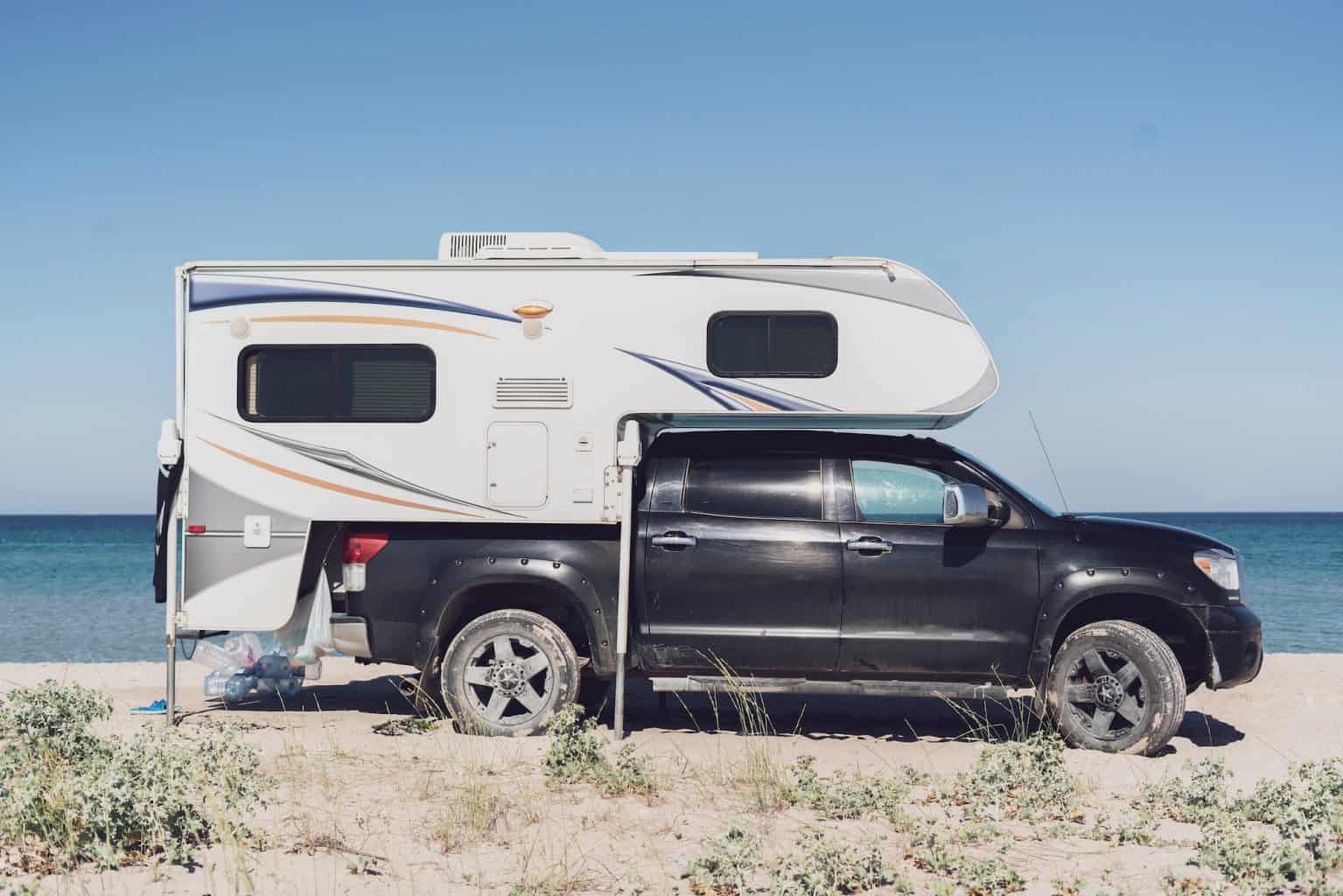 truck camper parked on beach