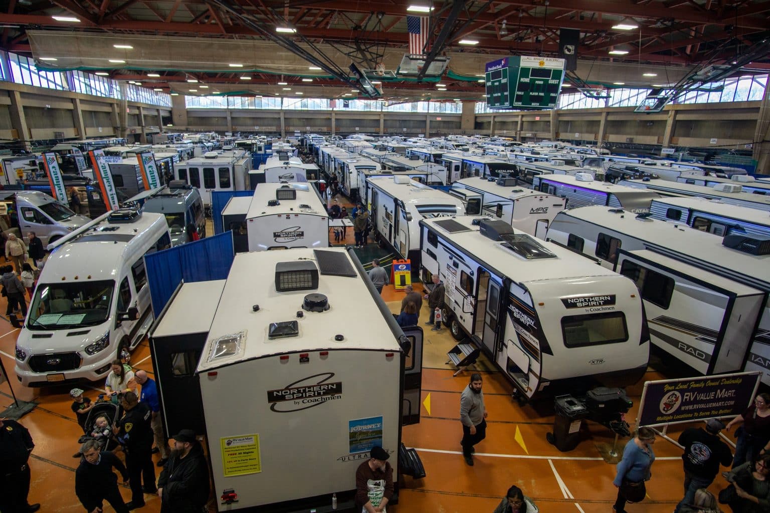 Buyers comparing RV show prices at a dealership event