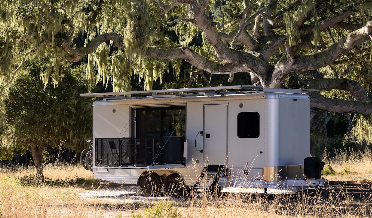 Living vehicle 2026 all electric travel trailer camping under tree