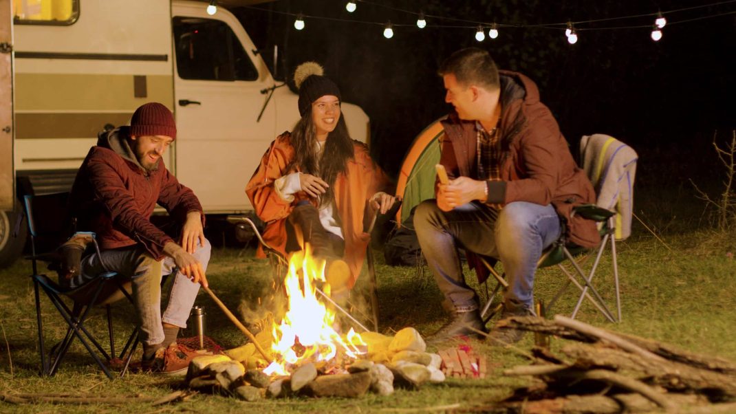 Group off friends sitting around a campfire