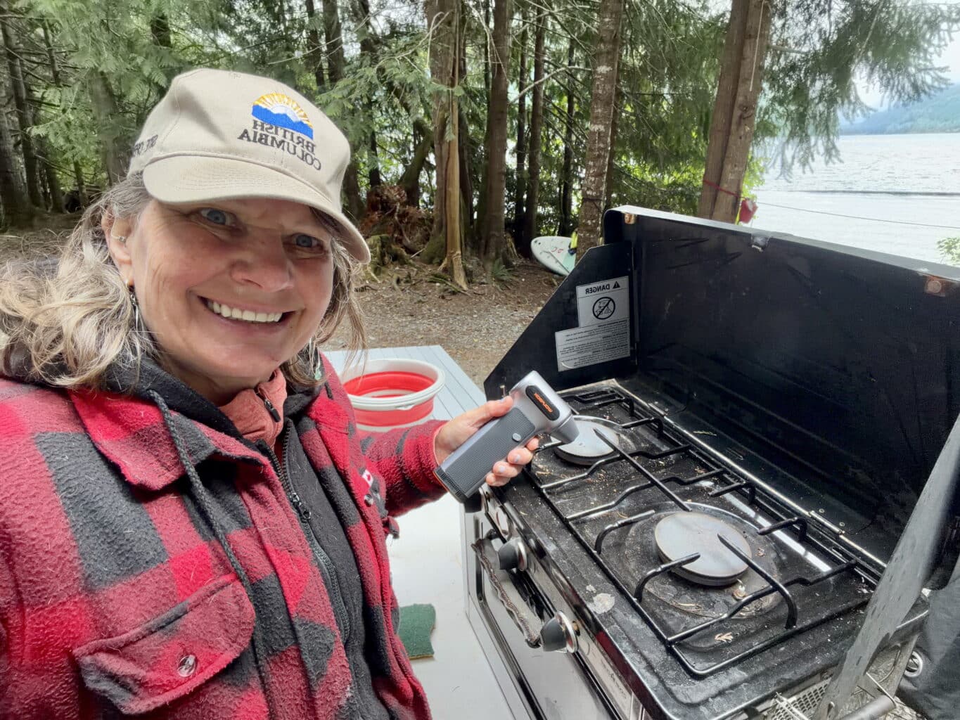 Lynne cleaning the camp stove with the Wolfbox MF200 Turbo fan