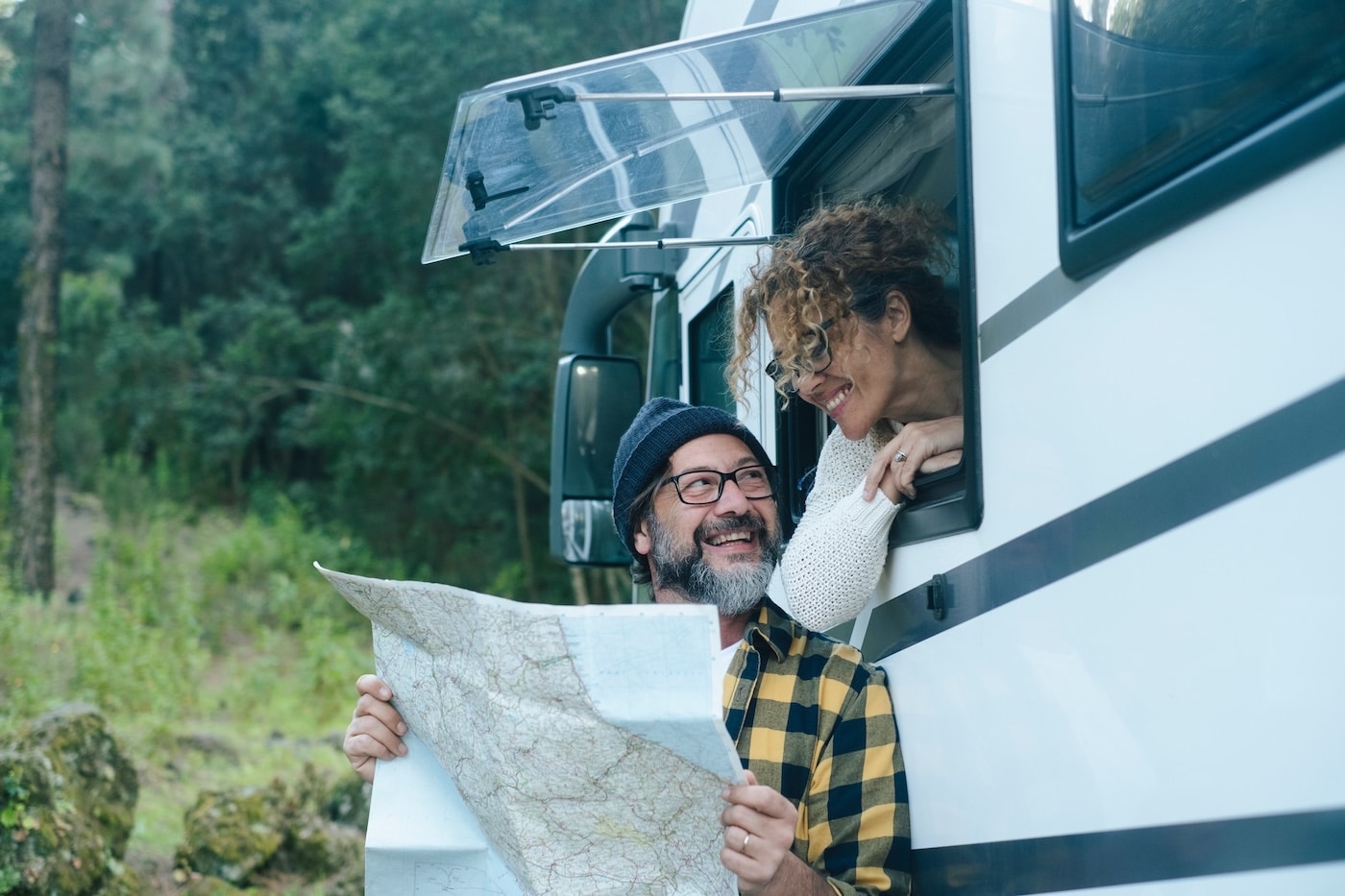 winter snowbird couple looking at map of vancouver island, BC